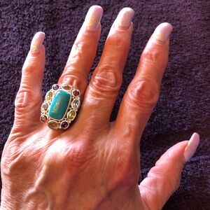 Rectangular shaped turquoise  surrounded by semi precious gemstones in silver